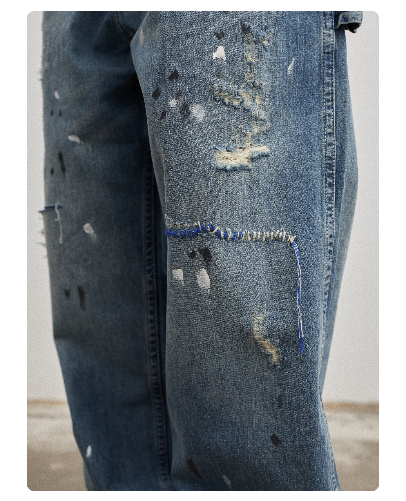 Ink-splashed ripped washed jeans